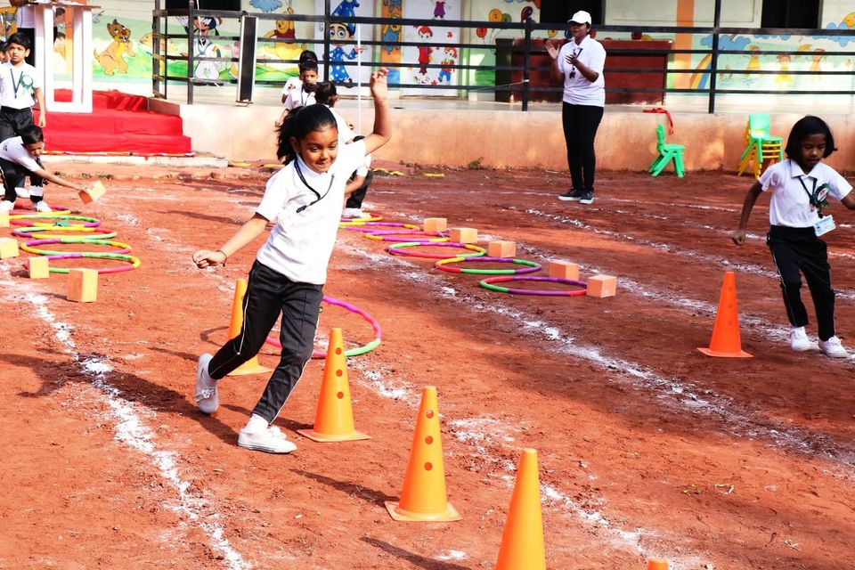 A student running the hoop course on the school ground