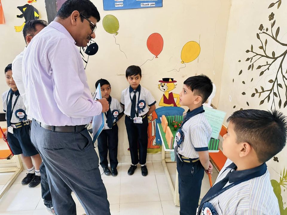 A teacher with pre-primary students in their classroom