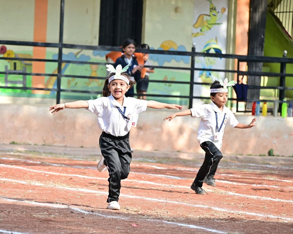 Two children running a race on the school ground