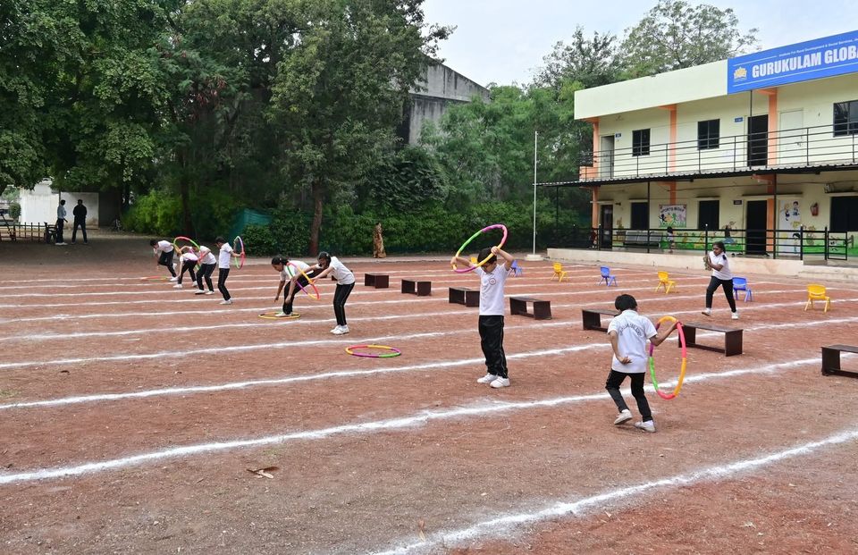 Hoop games on the school ground, with the school building behind