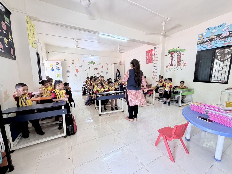 A pre-primary class in session with the teacher at the front