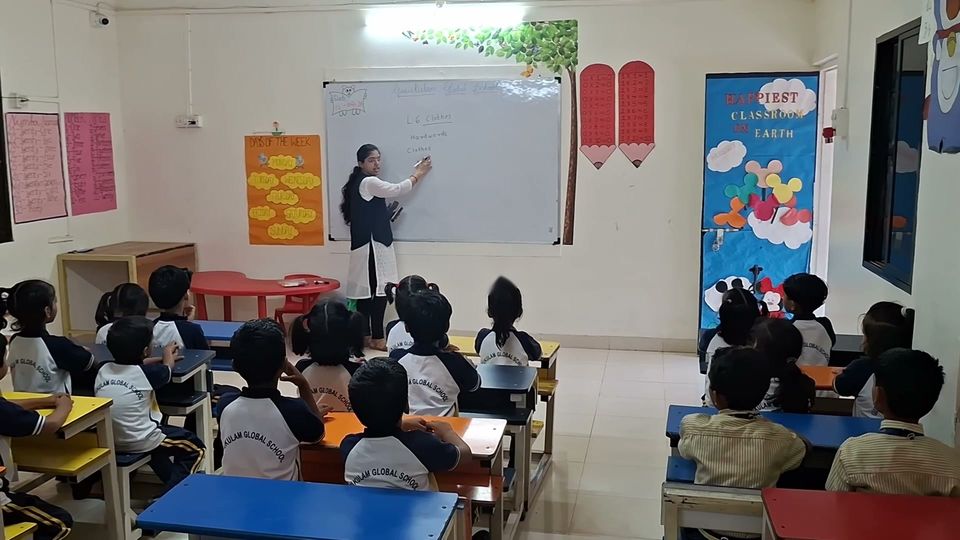 A primary class in session with the teacher at the whiteboard