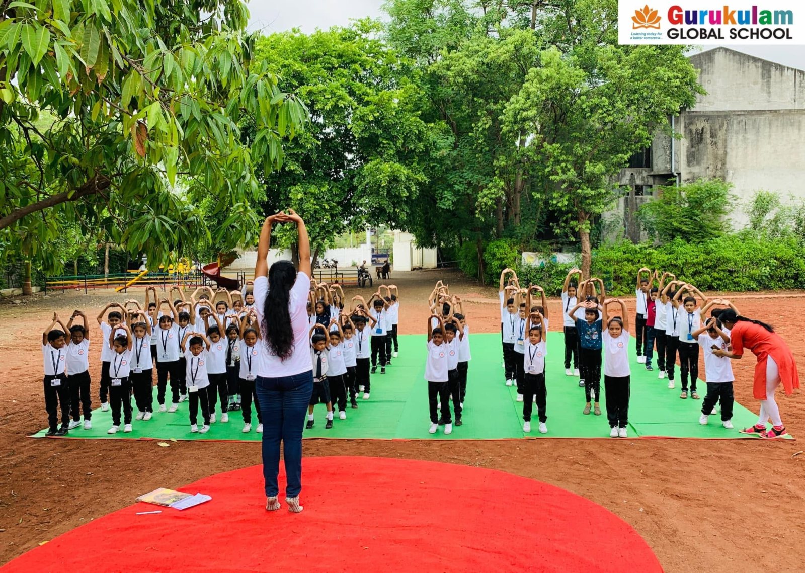 The whole school in tadasana on the ground