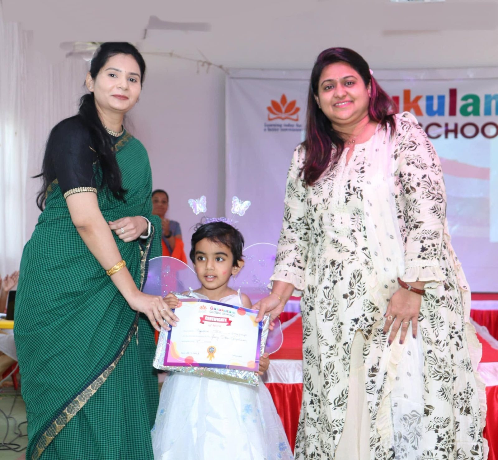 A participant receives her certificate from the guests