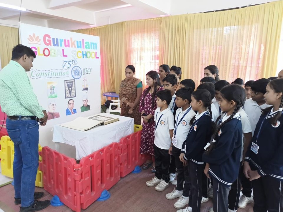 Classes gather around the Constitution display