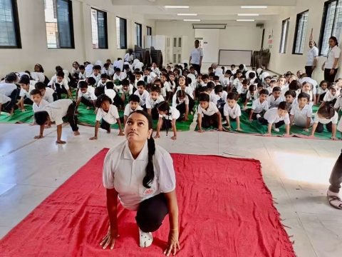 A teacher demonstrates the pose