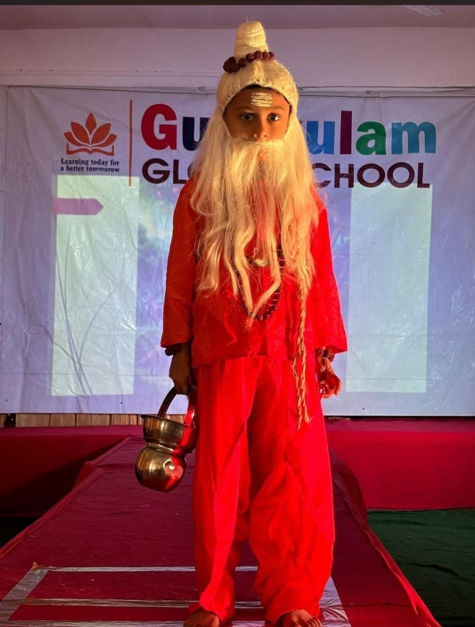A sage in red with his kamandal