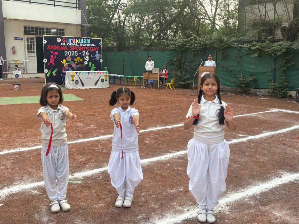 Pre-primary drill display in front of the Sports Day banner