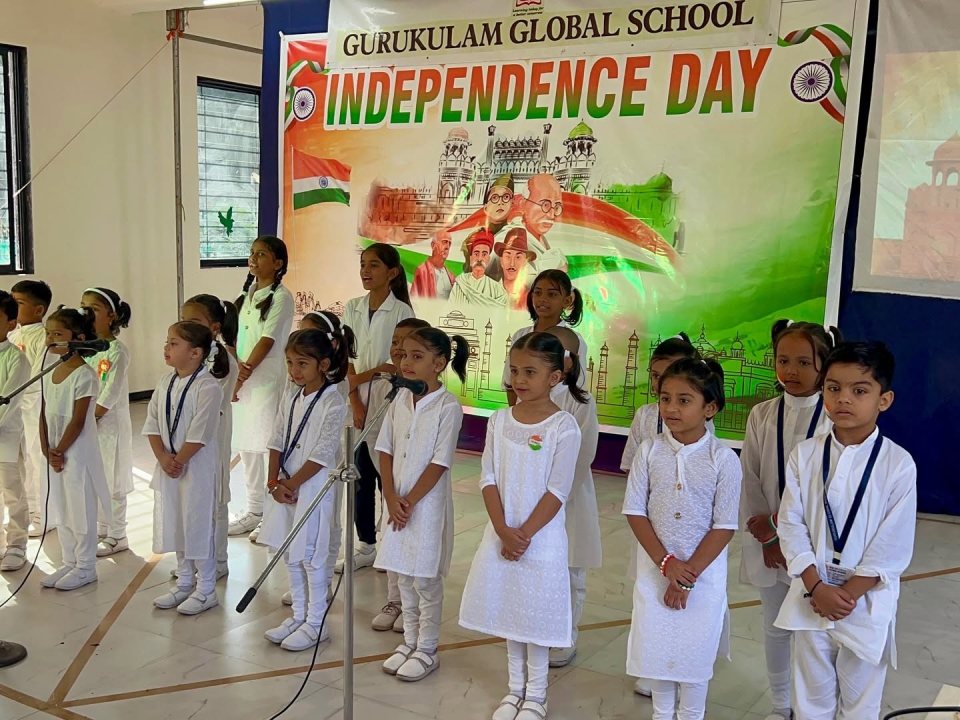 The choir in white before the Independence Day banner
