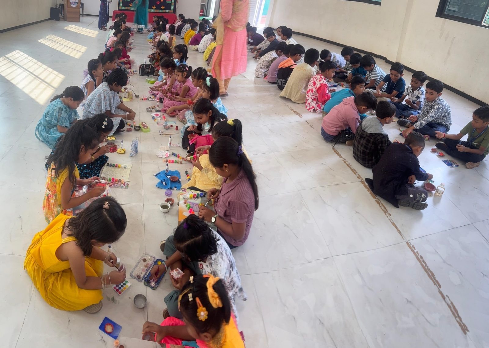 Diya painting fills the hall before Diwali