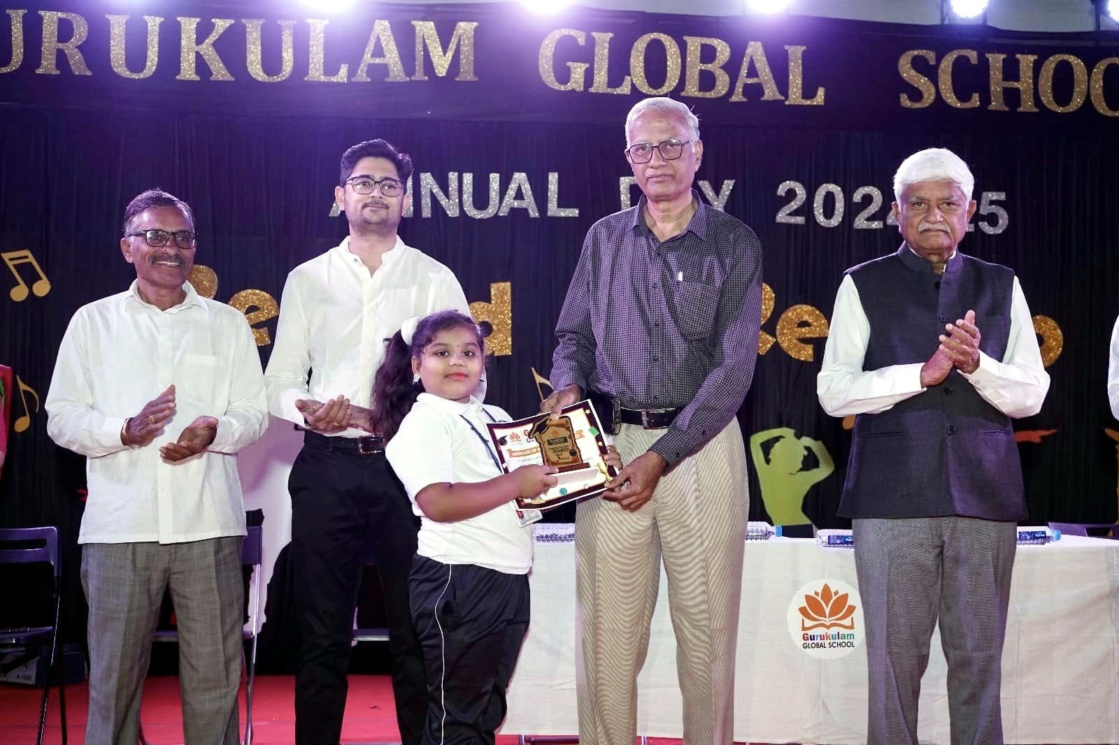 A student receives a memento from the guests on the dais
