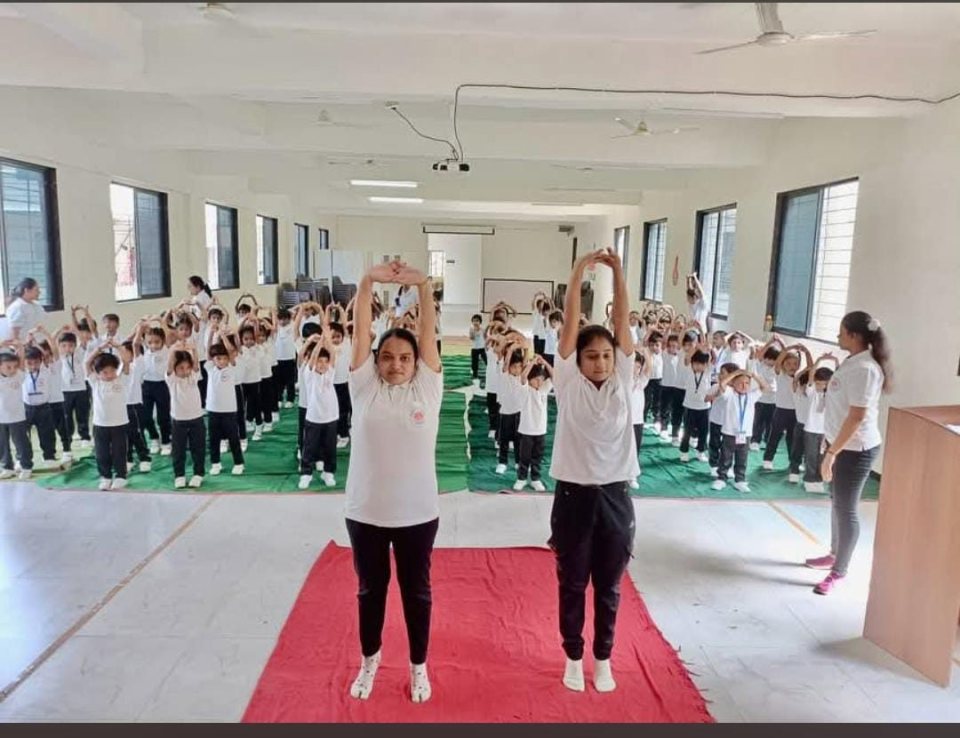 Two students lead the class from the front