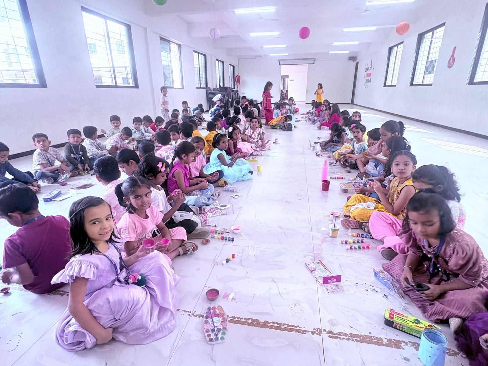 Every class paints diyas on the hall floor