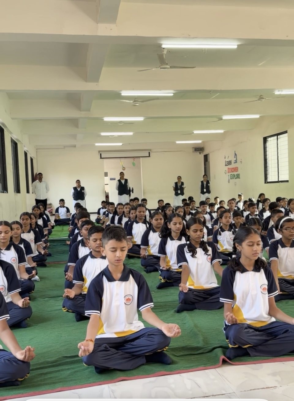 Senior students in meditation in the school hall